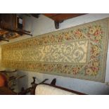 Aubusson style needlework runner with floral decoration on beige ground,