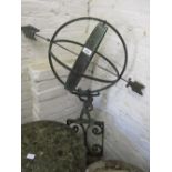 Patinated metal and wrought iron armillary sphere on a scroll work base,