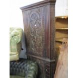 Large 19th Century carved oak standing corner cabinet with a moulded cornice above two carved