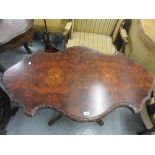 19th Century burr walnut shaped top centre table on five carved column supports and swept carved