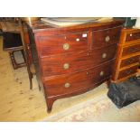 Small early 19th Century mahogany bow fronted chest of two short and two long drawers with circular