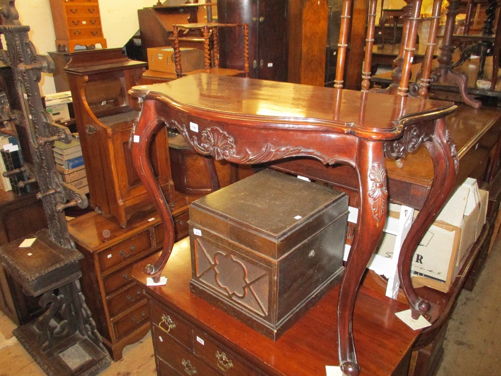 Reproduction mahogany side table with a shaped top,