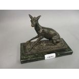 Small French brown patinated bronze figure of a seated fawn mounted on a rectangular marble base