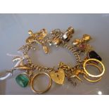 9ct Yellow gold charm bracelet with attached gold charms including a 22ct yellow gold wedding band