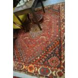 Shiraz rug with a centre medallion and bird decoration with multiple borders on a wine ground,