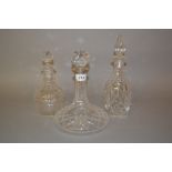 Silver mounted cut glass decanter and two other decanters