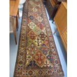 Machine made Persian pattern runner on beige ground,