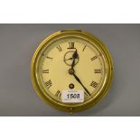 Circular brass cased ship's clock having white painted dial with Roman numerals and single train