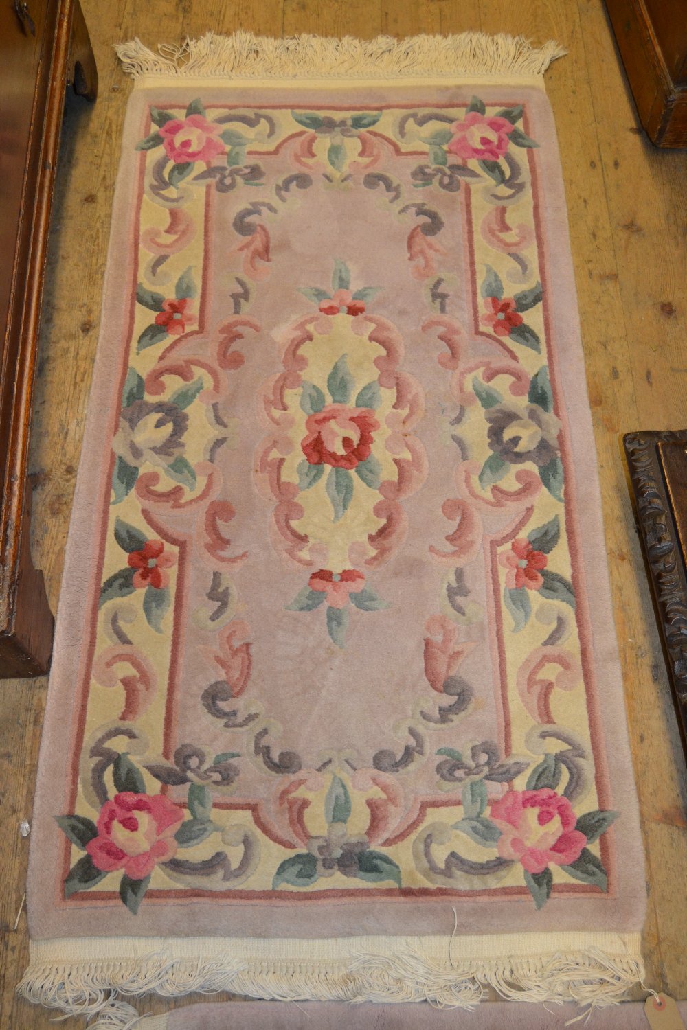 Pair of small Chinese rugs with embossed floral design on a beige ground together with a similar