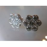 Pair of 18ct white gold seven stone diamond flowerhead stud earrings, approximately 2.
