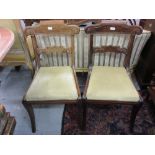 Set of four Regency mahogany shaped rail back dining chairs with drop-in seats on splay front