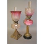 Victorian brass and pink opaque glass oil lamp with matching shade and chimney together with another