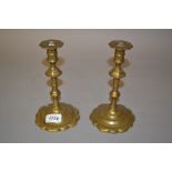 Pair of antique circular brass knopped stem candlesticks