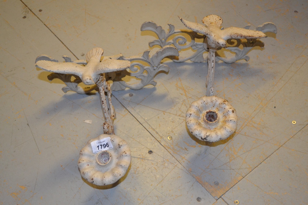 Pair of white painted cast iron single branch wall sconces mounted with a figure of a bird, together