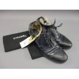 Pair of Chanel ladies dark blue / black leather brogue style shoes with open sides and ankle
