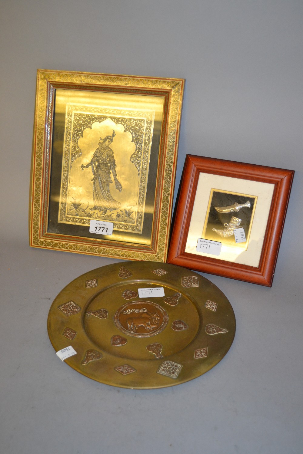 Far Eastern circular brass plate, framed Persian metal plaque and a framed miniature silver dagger