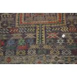 Large Kelim rug decorated with two gols and all-over figures and animals, with multiple borders, 7ft