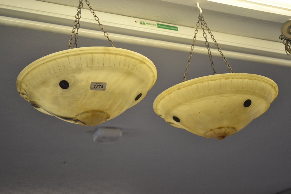 Pair of early 20th Century alabaster hanging shades with anodised copper fittings Unfortunately, one