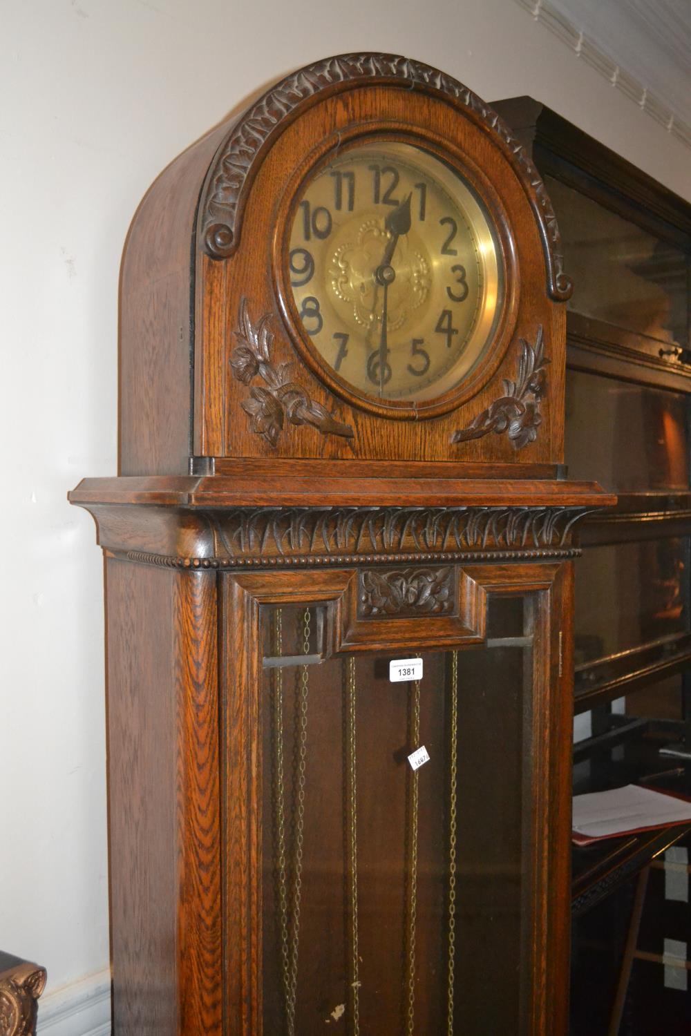 Early 20th Century carved oak longcase clock, the dome hood above a circular dial and moulded glazed