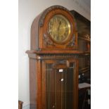Early 20th Century carved oak longcase clock, the dome hood above a circular dial and moulded glazed