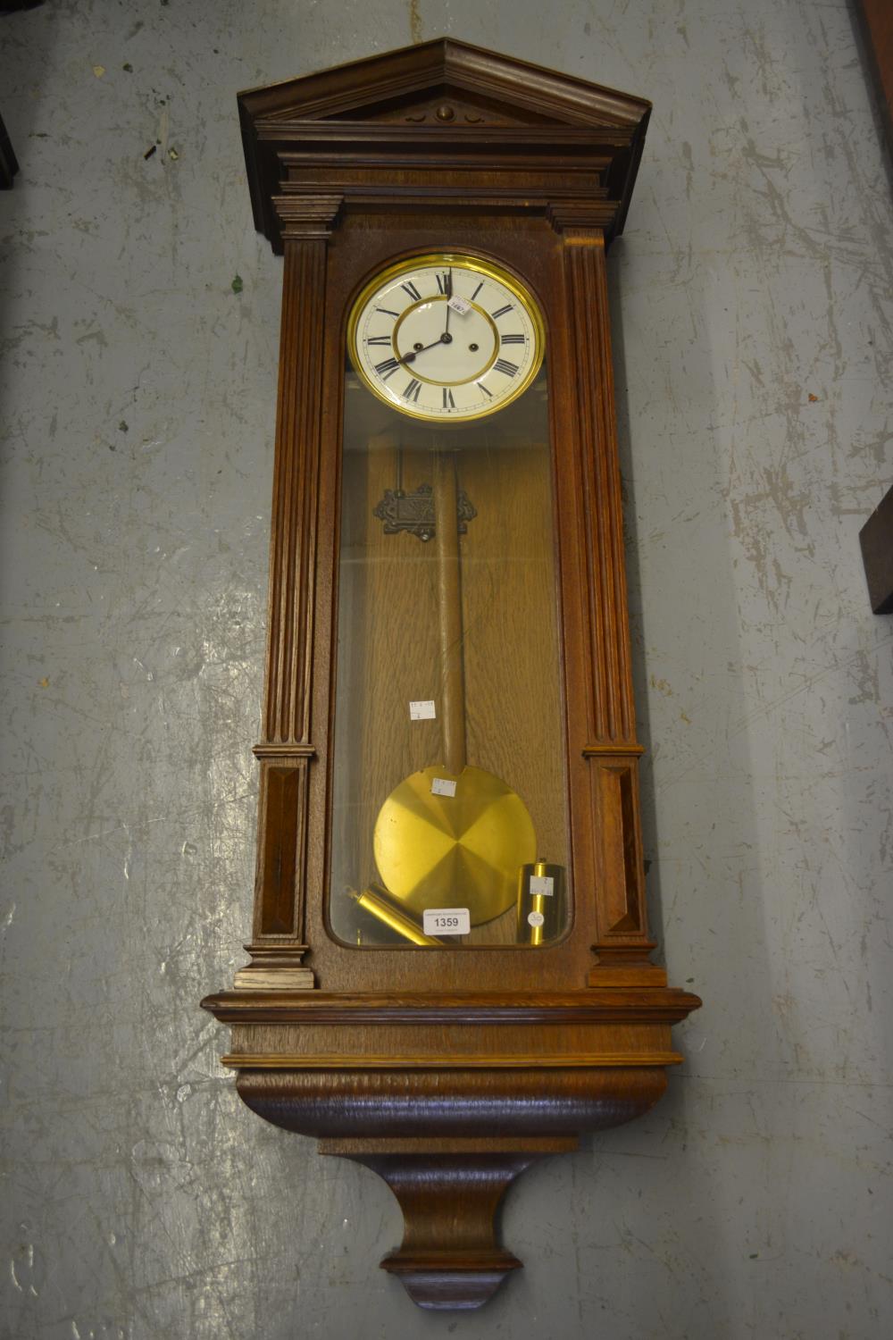 Late 19th or early 20th Century oak cased Vienna wall clock, the enamel dial with Roman numerals,