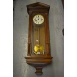 Late 19th or early 20th Century oak cased Vienna wall clock, the enamel dial with Roman numerals,