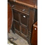 Oak sideboard with two carved drawers above panelled doors on stile feet