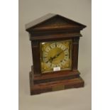 Edwardian mahogany bracket clock, the architectural case with flanking pilasters, the gilt brass