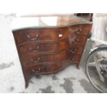 Early to mid 20th Century walnut chest of four graduated drawers, the serpentine front above splay