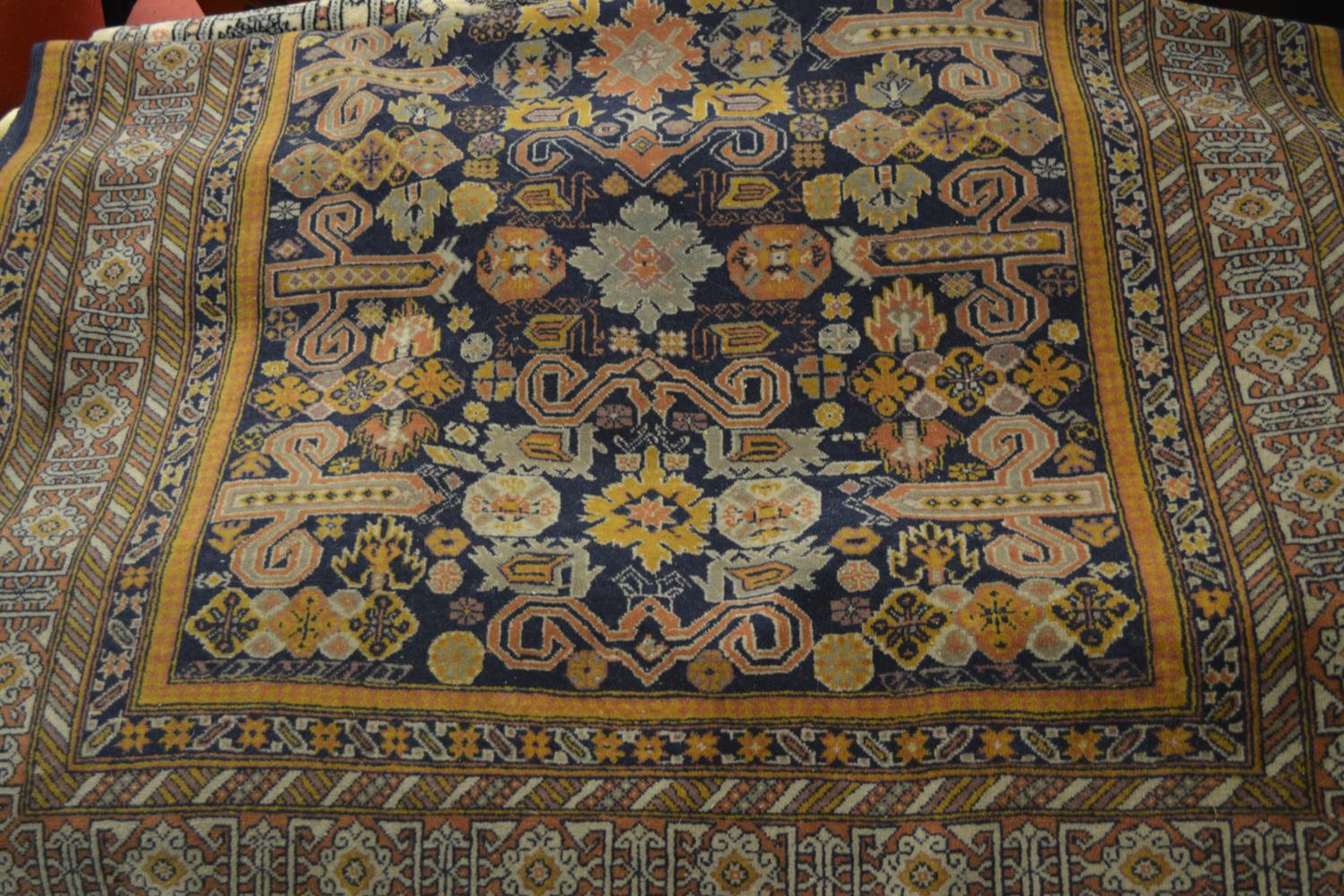 Turkish rug of Caucasian design with an all-over stylised floral and rams head design on a