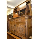 Reproduction oak dresser with a boarded shelf back above drawers and cupboards