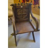 Late 19th or early 20th Century oak Glastonbury chair with panel back and crossover supports