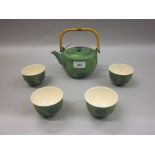 Japanese sake / teapot and four cups decorated in a mottled green matt glaze