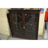 Edwardian mahogany bookcase, the carved dentil cornice above two astragal glazed doors flanked by