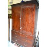 19th Century mahogany linen press having a moulded cornice above two flush panelled oval crossbanded