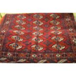 Bokhara rug having multiple borders with three lines of gols on a wine ground, 4.5ft x 3ft