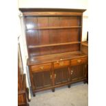 19th Century oak dresser, the boarded shelf back above three drawers and three panelled doors on