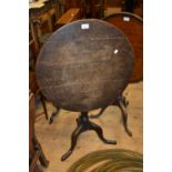 George III circular oak tilt-top pedestal table on turned centre column and tripod support