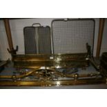 Two 19th Century brass fenders together with two brass firescreens and a quantity of fire tools