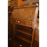 Small Arts and Crafts oak bureau, carved spinning chair and two occasional tables