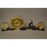 Art Deco black slate and marble three piece clock garniture, the dial with Arabic numerals and