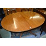 Mahogany twin pedestal dining table with a single central extra leaf (the table closing to form a