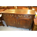 18th Century French oak dresser, the moulded plank top above two drawers and two shaped panel