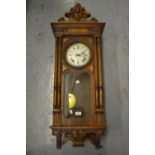 Late 19th or early 20th Century Continental walnut Vienna wall clock, the shaped surmount above an