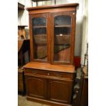 Victorian mahogany bookcase, the moulded cornice above two glazed doors, a long drawer and two panel