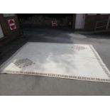 Large Tunisian woollen carpet of floral design with border on a beige ground, 13ft x 10ft