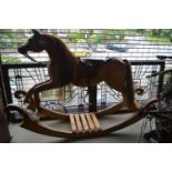 Child's 20th Century laminated wooden rocking horse, 5ft wide x 42ins high x 31ins to the saddle