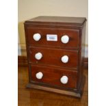 19th Century miniature three drawer table top chest with white ceramic handles