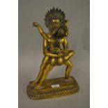 Asian gilt bronze erotic group of two figures, 15ins high