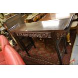 Chinese hardwood altar table, the rectangular top with scroll ends above a carved and pierced frieze